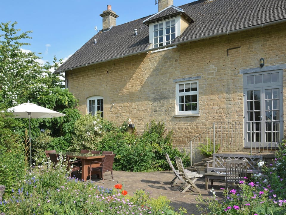 Rear patio with outdoor furniture | Newmarket - Bruern Holiday Cottages, Bruern, near Chipping Norton