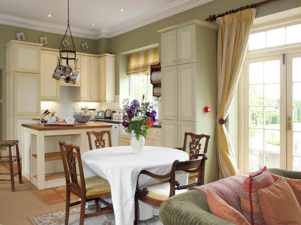 Well-equipped fitted kitchen and convenient dining area | Sandown - Bruern Holiday Cottages, Bruern, near Chipping Norton