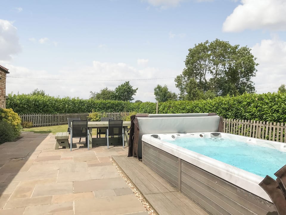 Outdoor area with large hot tub | Field Maple Barn - Ashlin Farm Barns, Dunholme, near Lincoln