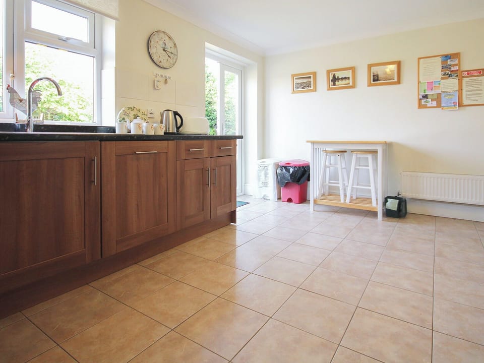 Large well-equipped kitchen with French doors to the garden | Woodside Cottage, Sandford, near Shanklin