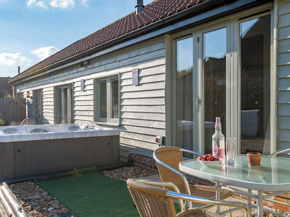 Courtyard with sitting-out area, garden furniture and bbq | The Milking Parlour - Manor Mews, Tattersett, near Fakenham