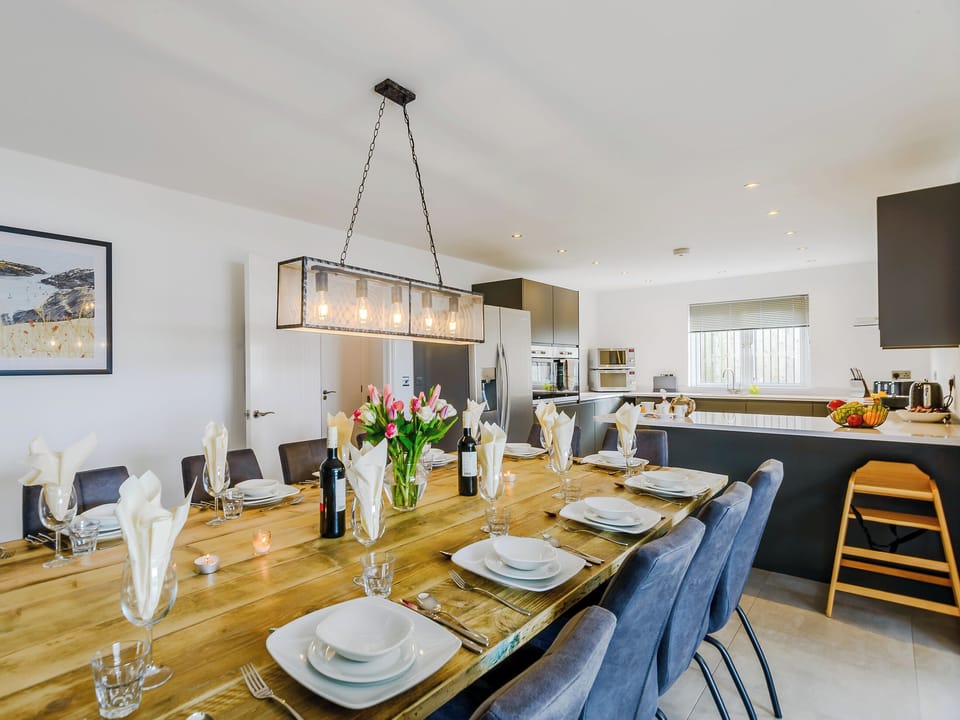 Attractive dining area leading into the kitchen | Meusydd - Gwbert Holiday Cottages, Gwbert, near Cardigan