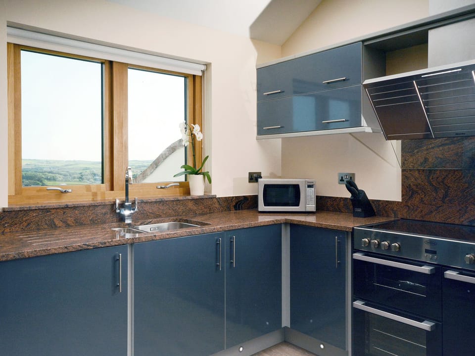 Kitchen area with views to the countryside | Milky Way - Wooldown Holiday Cottages, Marhamchurch, near Bude