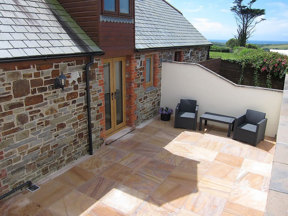 Lovely sunny flagged patio | Dreamcatcher - Wooldown Holiday Cottages, Marhamchurch, near Bude