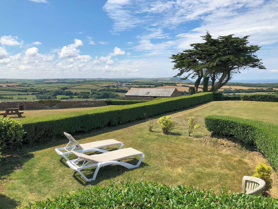 Delightful garden with sitting out area | Wenna&rsquo;s Well - Wooldown Holiday Cottages, Marhamchurch, near Bude