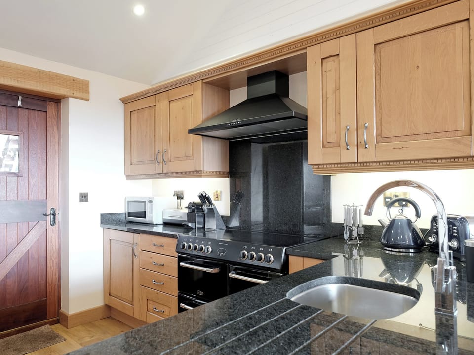 Well presented kitchen area | Dewdrop Dairy - Wooldown Holiday Cottages, Marhamchurch, near Bude