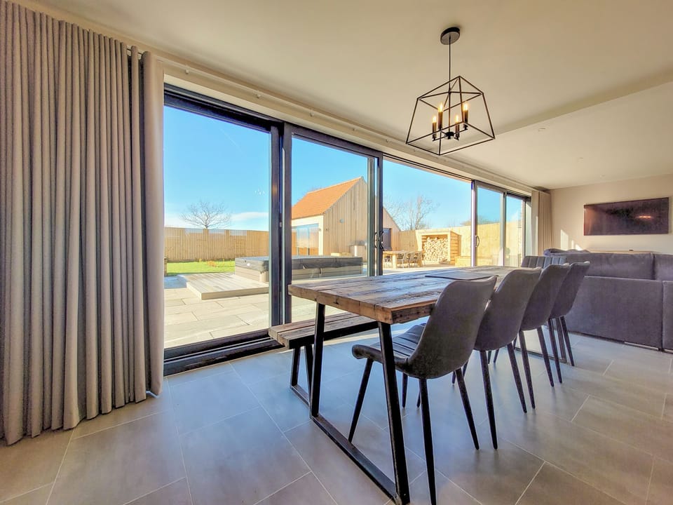 Dining area, bifold doors to garden | Eastgate Barn - Ashlin Farm Barns, Dunholme, near Lincoln