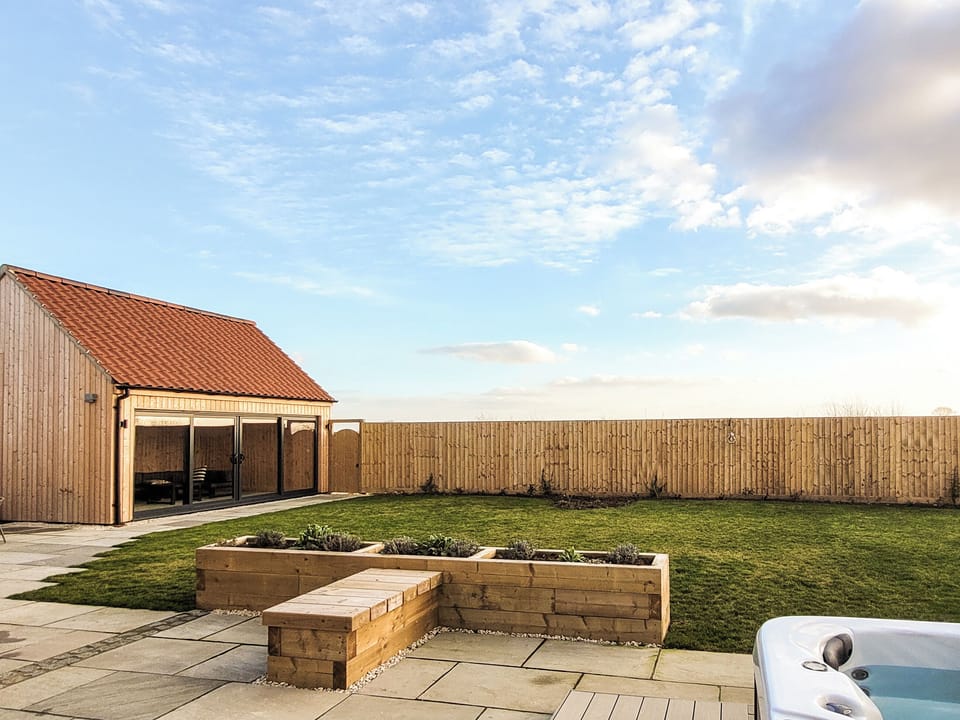 Garden view with hot tub | Rowan House - Ashlin Farm Barns, Dunholme, near Lincoln