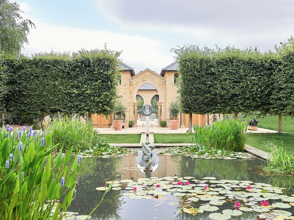Imposing courtyard viewed across the mirror pond | Kingham Cottages, Kingham, near Chipping Norton