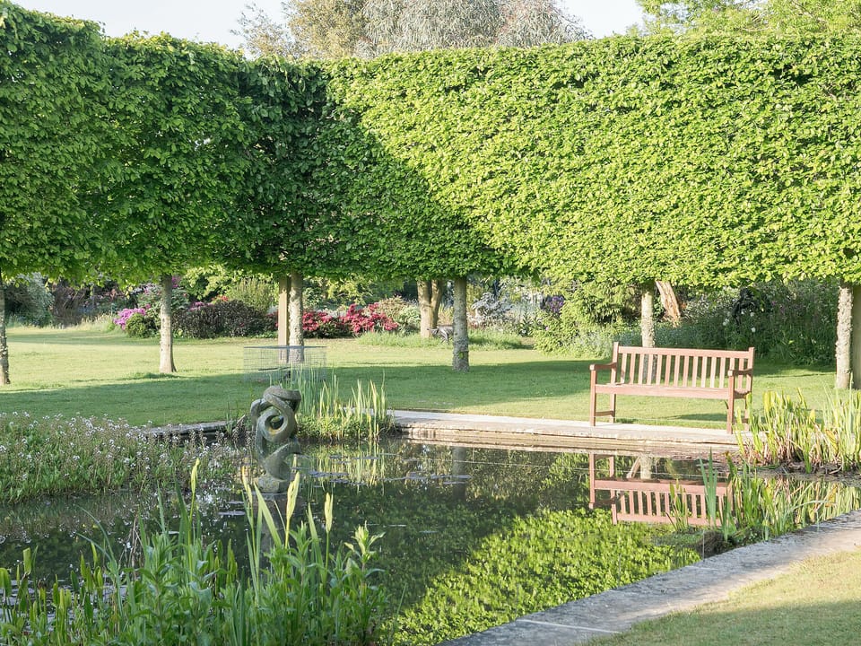 Beautiful mirror pool with peaceful seating area | Kingham Cottages, Kingham, near Chipping Norton