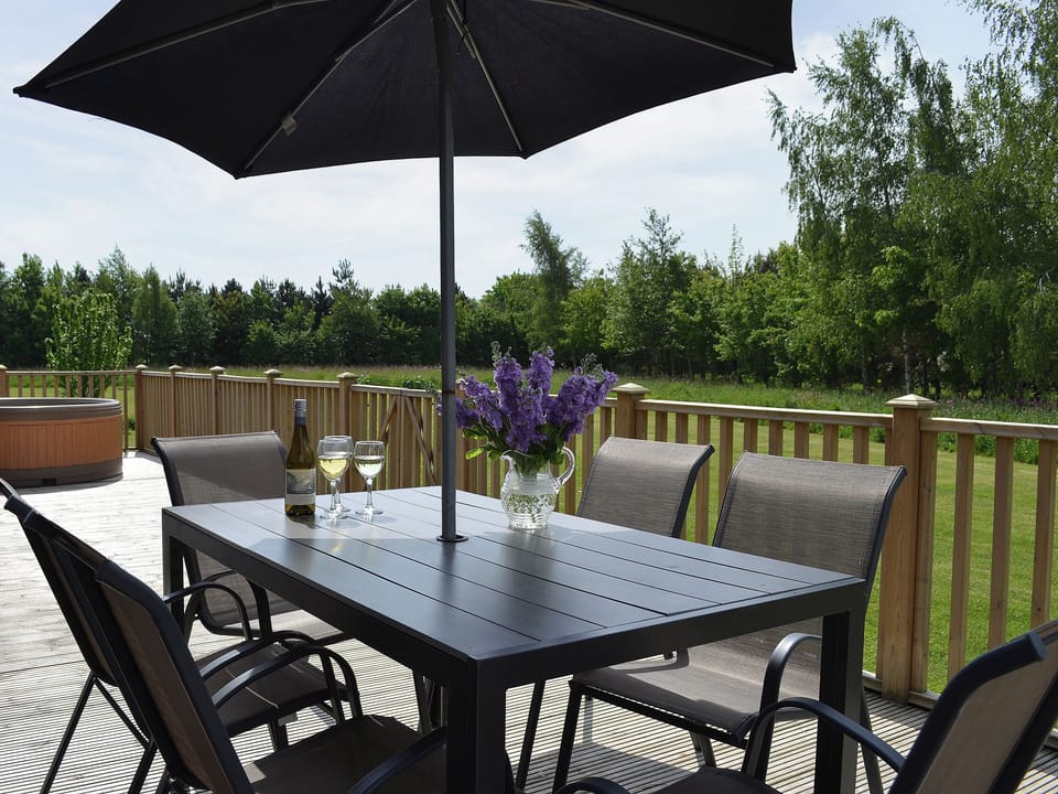Decked area with table and chairs for alfresco dining | Quail Lodge - Mackinder Farms, Brayton, Selby