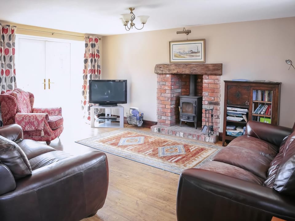 The lounge benefits from the light provided by the French windows | Miller&rsquo;s House - Millmoor Farm, Bickley, near Malpas