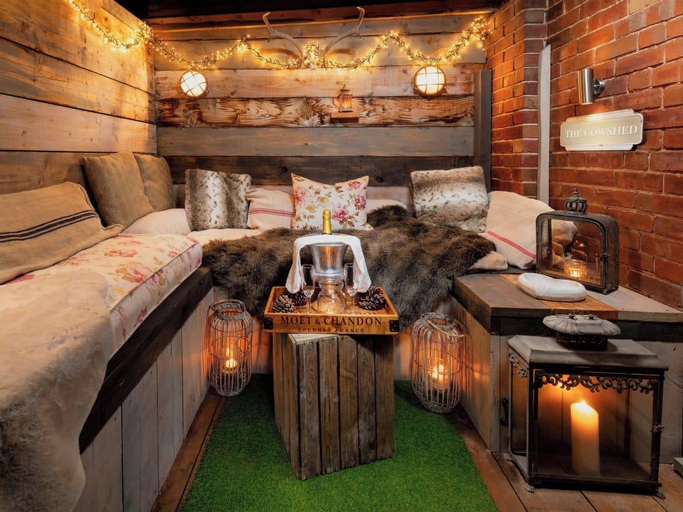 Under cover outdoor seating with hidden bath! | The Cowshed - Cheshire Boutique Barns, Wrenbury, near Nantwich