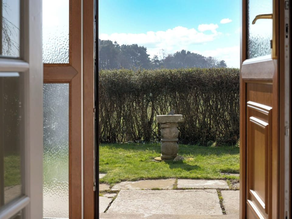 Front door exit to garden | Kirktoun Cottage, Duffus, near Lossiemouth