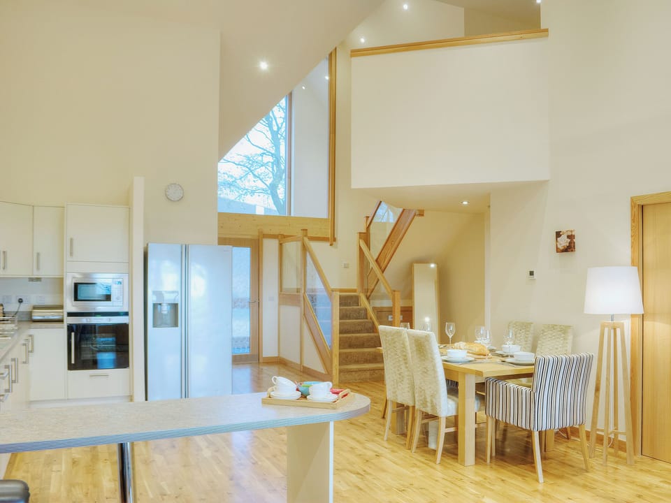 Kitchen area with dining area and grand staircase | , 