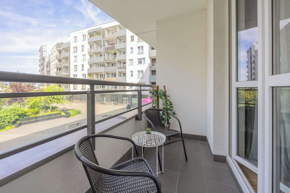 Another angle of the balcony, showcasing the outdoor seating area and potted plant. Ideal for enjoying fresh air in a private setting.