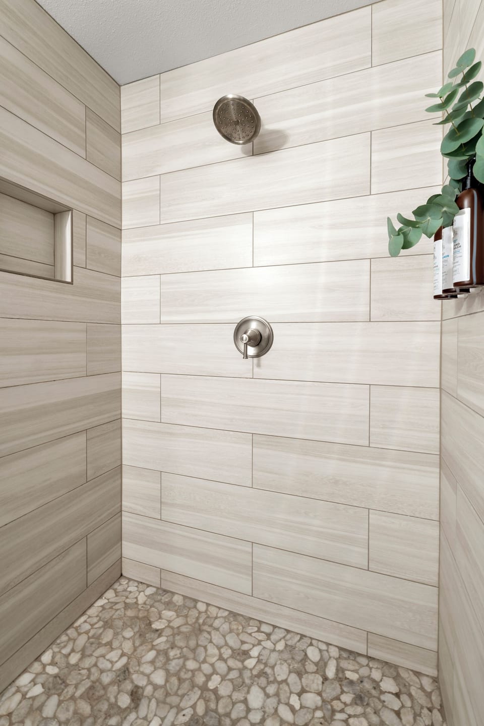 Step into your private spa-like shower with stunning wood-look tiles and pebble flooring that feels amazing beneath your feet.