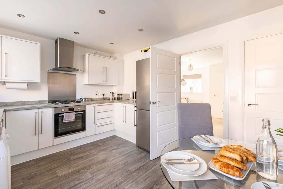 Enjoy a well‑equipped kitchen with stainless steel appliances, ample counter space, and minimalist décor. Whether whipping up a meal or brewing tea, this space is designed for convenience and style.