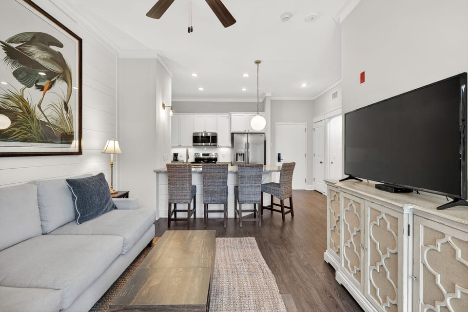 Living room area open to breakfast bar and kitchen.