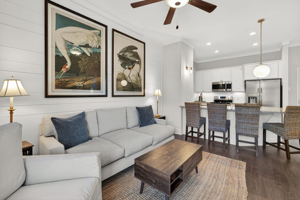 Living room area open to breakfast bar and kitchen.