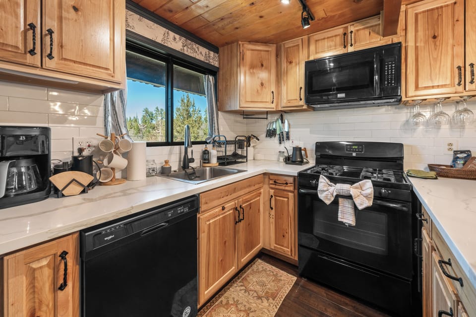 Full Kitchen - The upscale galley kitchen features quartz countertops, a gas range, and modern appliances, making meal prep simple and enjoyable.