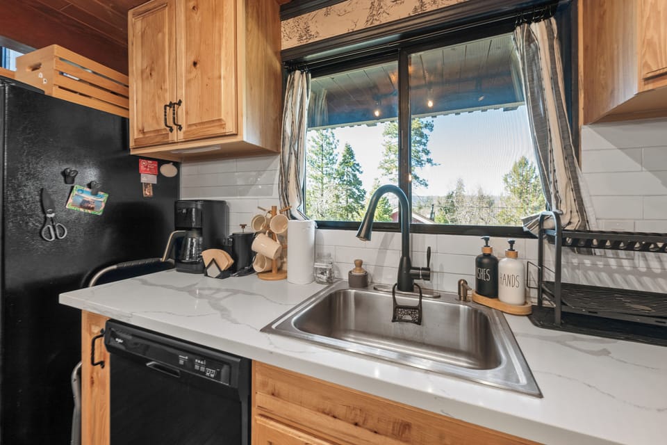 Full Kitchen - The upscale galley kitchen features quartz countertops, a gas range, and modern appliances, making meal prep simple and enjoyable.