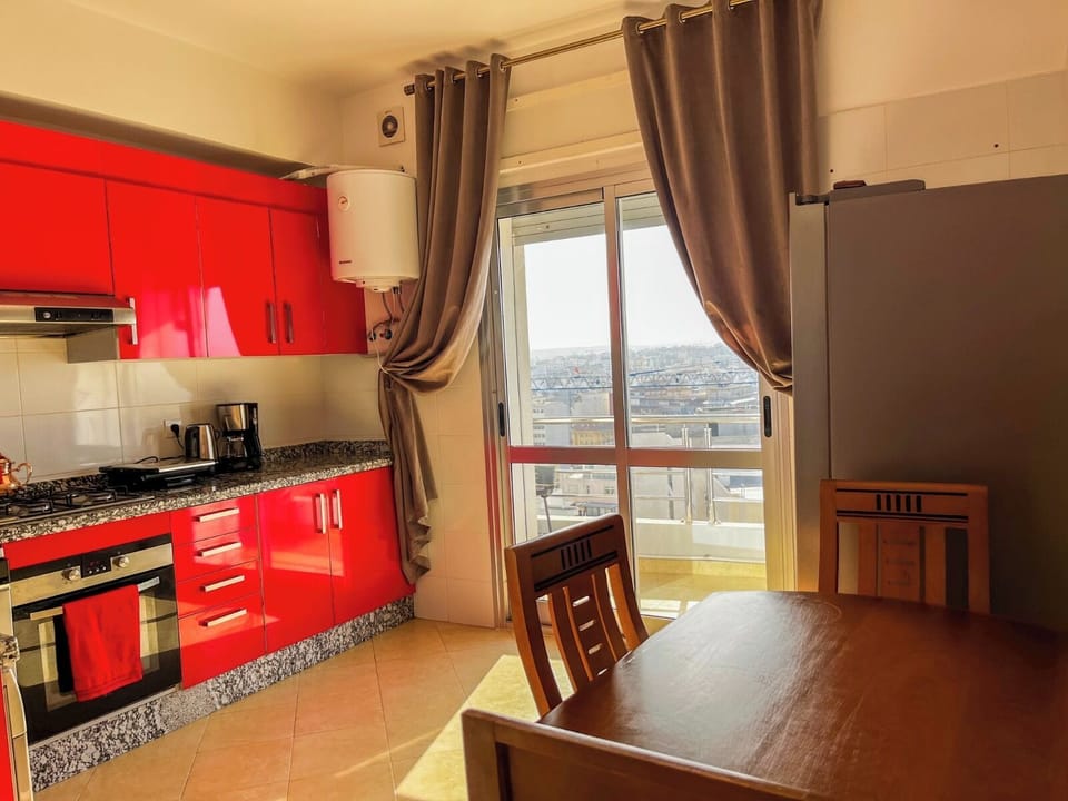 Kitchen with dining table with 4 chairs and sliding door with direct access to balcony