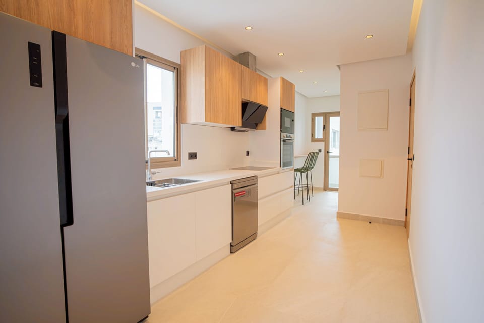 Pearl Kitchen with sink, LG dishwasher, LG stove top with vent, built-in LG oven and microwave