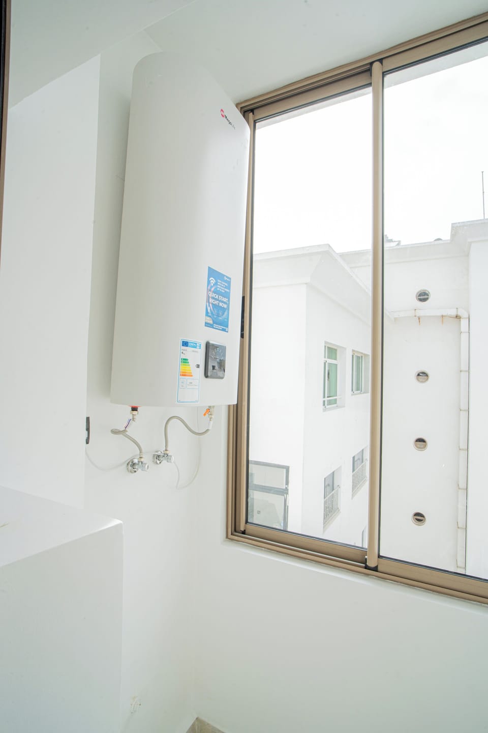Utility closet with smart hot water heater (80L capacity) and window