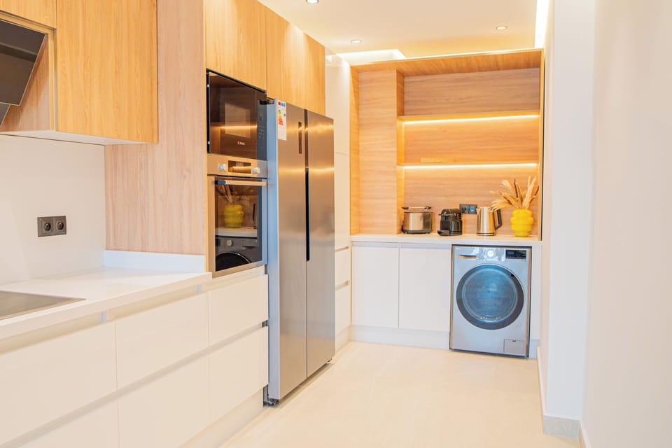 Kitchen with LG Refrigerator (Side-by-Side 423L capacity), LG washer (8KG - 68L capacity), water kettle, coffee espresso machine, and toaster 