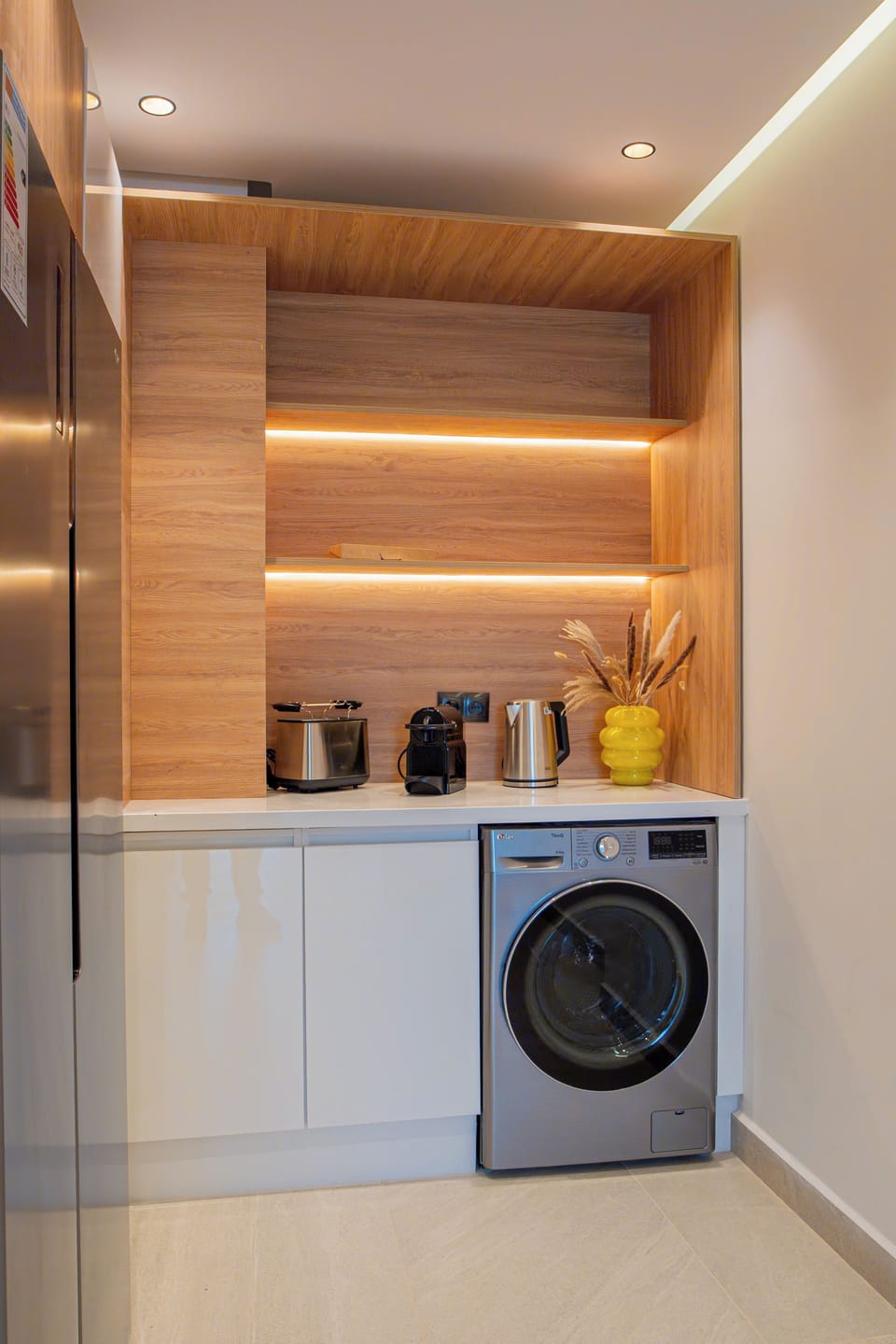 Kitchen with LG Refrigerator (Side-by-Side 423L capacity), LG washer (8KG - 68L capacity), water kettle, coffee espresso machine, and toaster 