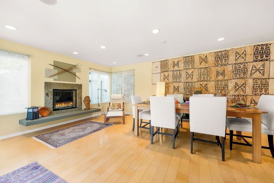A stylish indoor fireplace sits next to the dining area, adding cozy ambiance and a touch of elegance to every meal and gathering.