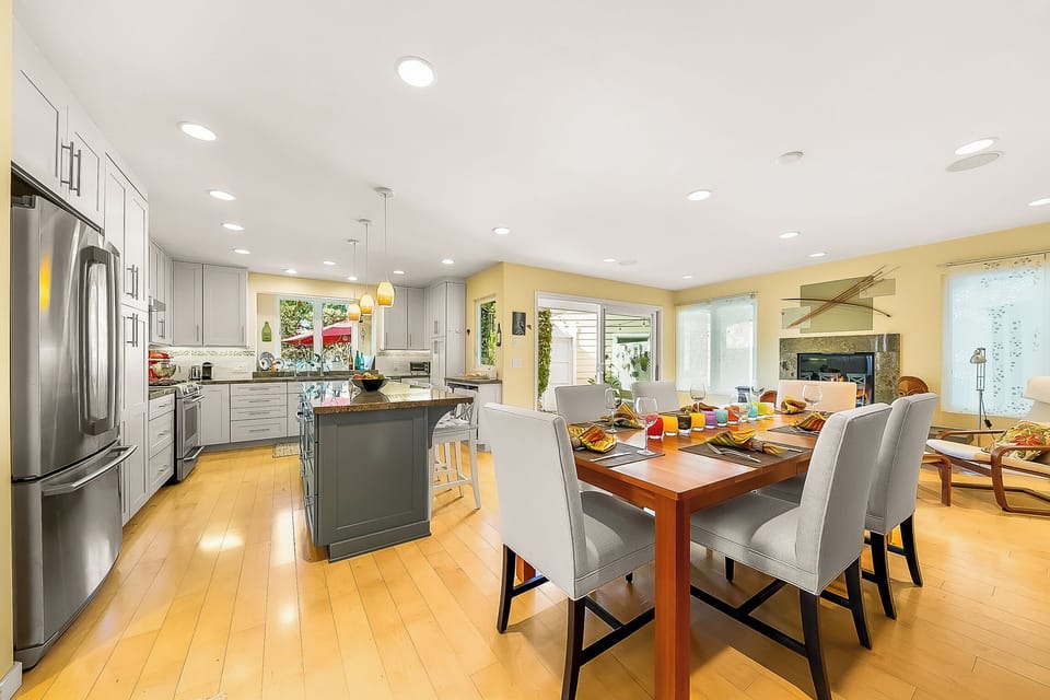 Sleek and spacious, the open-concept kitchen and dining area is perfect for cooking, dining, and socializing all in one bright, airy space. 