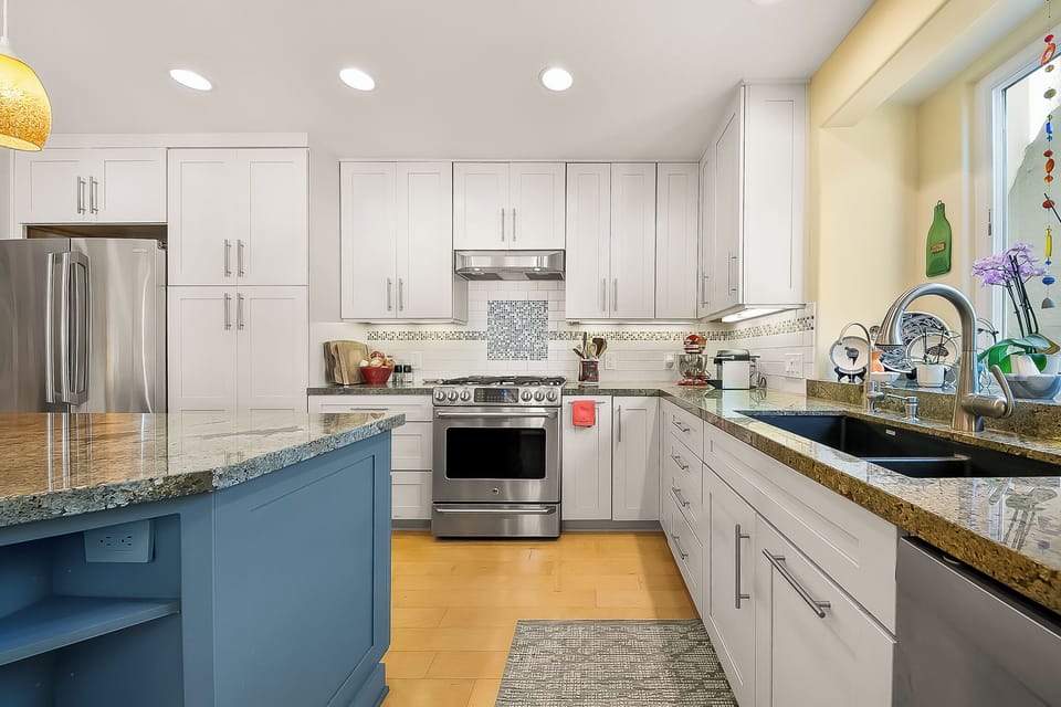 The modern kitchen boasts sleek stainless steel appliances, combining style and functionality for effortless cooking and entertaining.