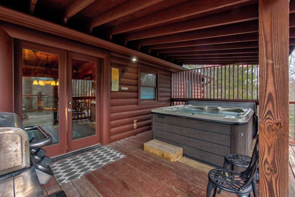 Unwind on your private covered deck with bubbling hot tub and forest views—perfect for starlit soaks after mountain adventures.
