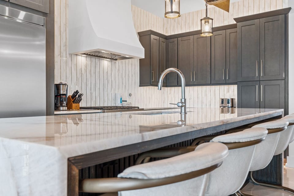 Your spacious kitchen awaits with gleaming counters, modern appliances, and plenty of room to gather around the island for meals and conversation.