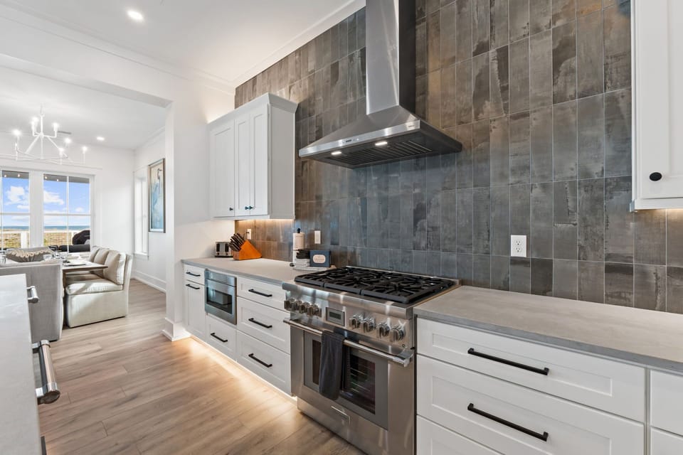 Create culinary magic in this sleek kitchen with premium appliances, elegant tile backsplash, and ample counter space for your vacation cooking adventures.