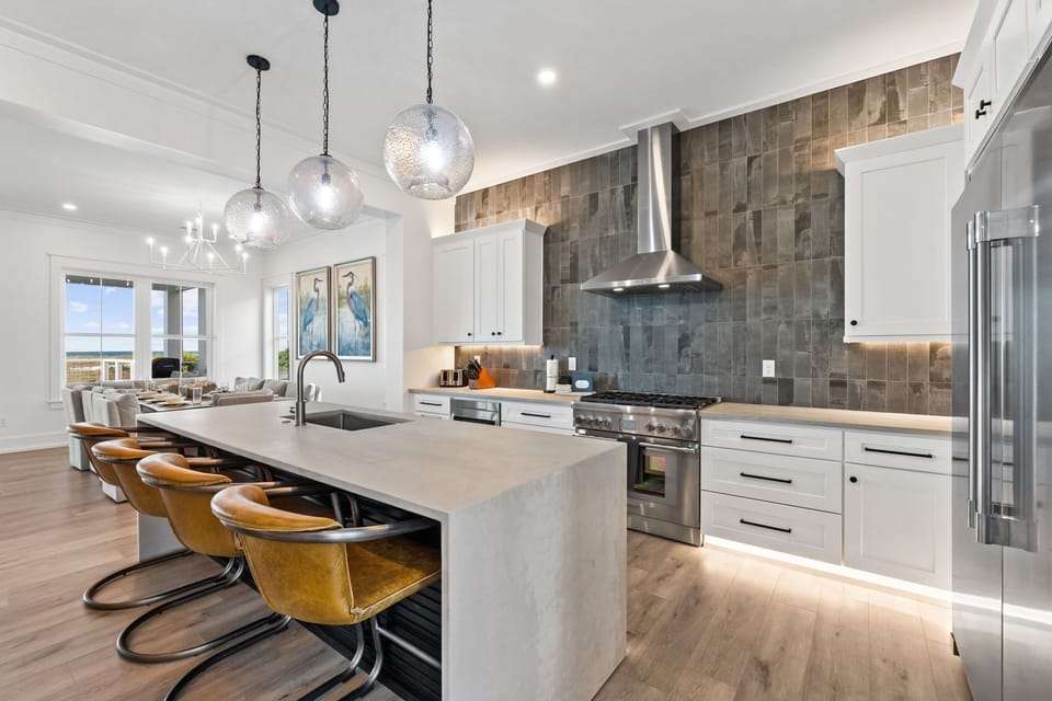 Your gourmet kitchen awaits with sleek appliances, stunning pendant lighting, and a spacious island perfect for cooking memorable meals together.