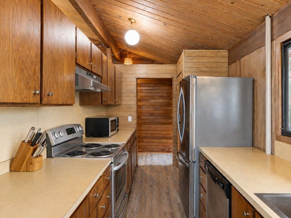 Narrow kitchen layout with fully stocked amenities