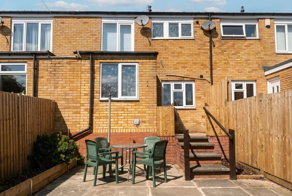 Step outside to a sunny private patio with a table and chairs for al fresco dining.
