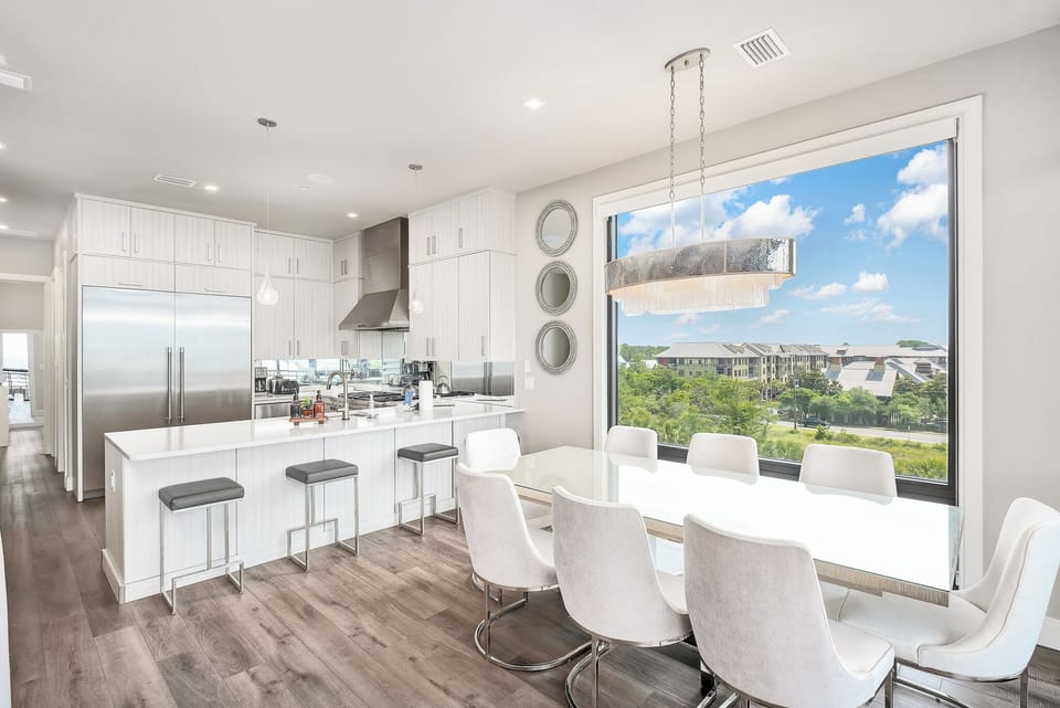 Modern coastal elegance meets comfort with a chef’s kitchen, luxurious dining area, and beautiful views.