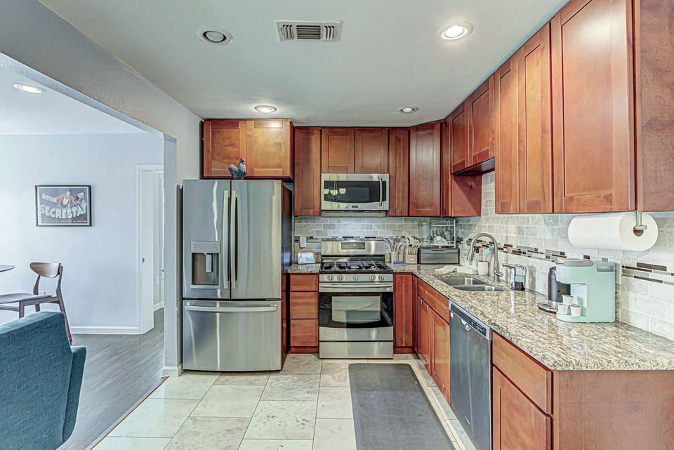 Modern kitchen with stainless steel appliances.