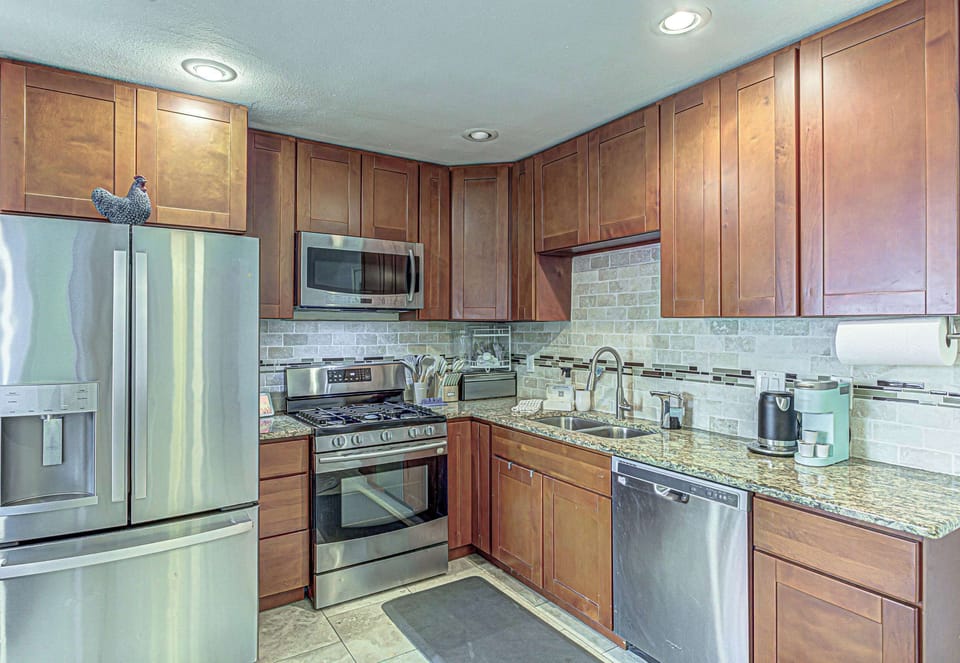 Modern kitchen with stainless steel appliances.