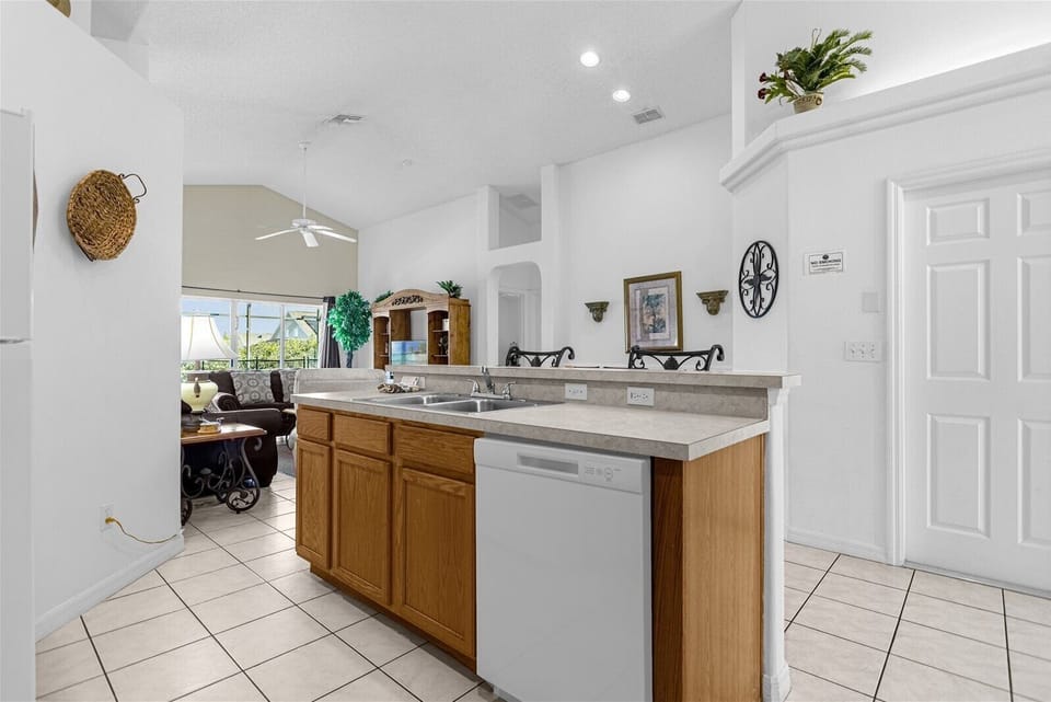 Kitchen Area With Sink, Dishwasher & Breakfast Bar Area That Seat 2 People