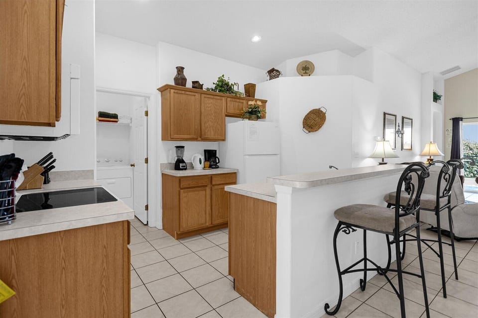 Kitchen Area With Full Size Fridge, Kettle, Coffee Maker, Blender & Bar