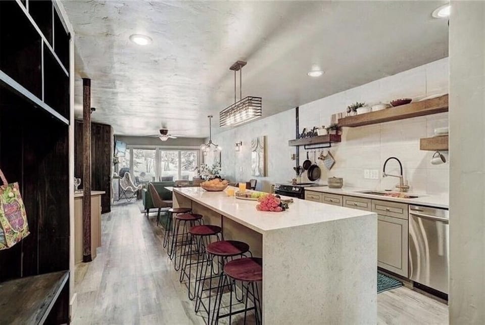 Your gourmet kitchen awaits with a spacious island, modern appliances, and warm wood accents—perfect for creating memorable meals together.