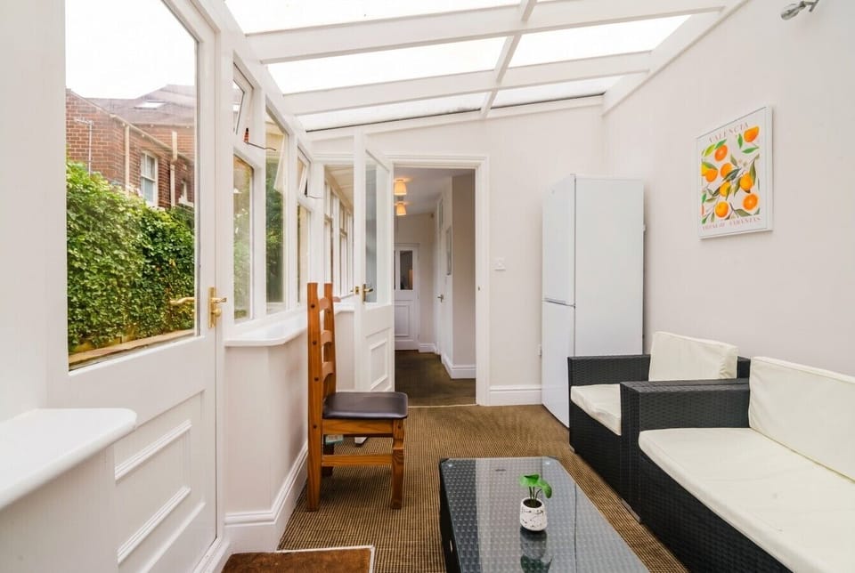 Sun-filled garden room with sofas and a peaceful spot to unwind