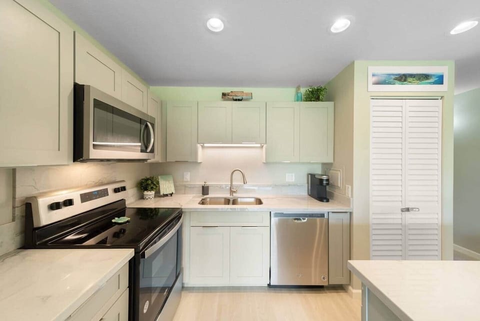 Bright and modern kitchen with stainless steel appliances.  