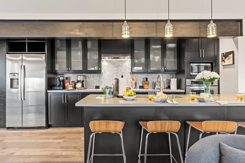 Your gourmet kitchen includes a gas range, large fridge, and plenty of counter space for prep and gathering.