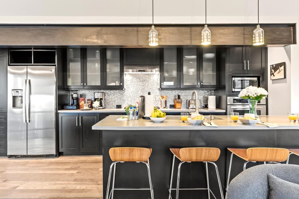 Your gourmet kitchen includes a gas range, large fridge, and plenty of counter space for prep and gathering.